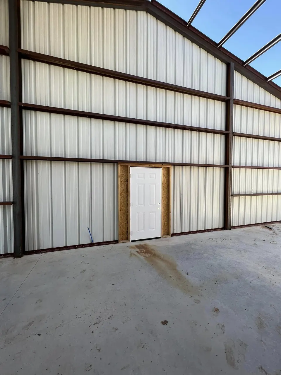 Interior of Homerun Fabrication production shop with corrugated panel walls and red columns