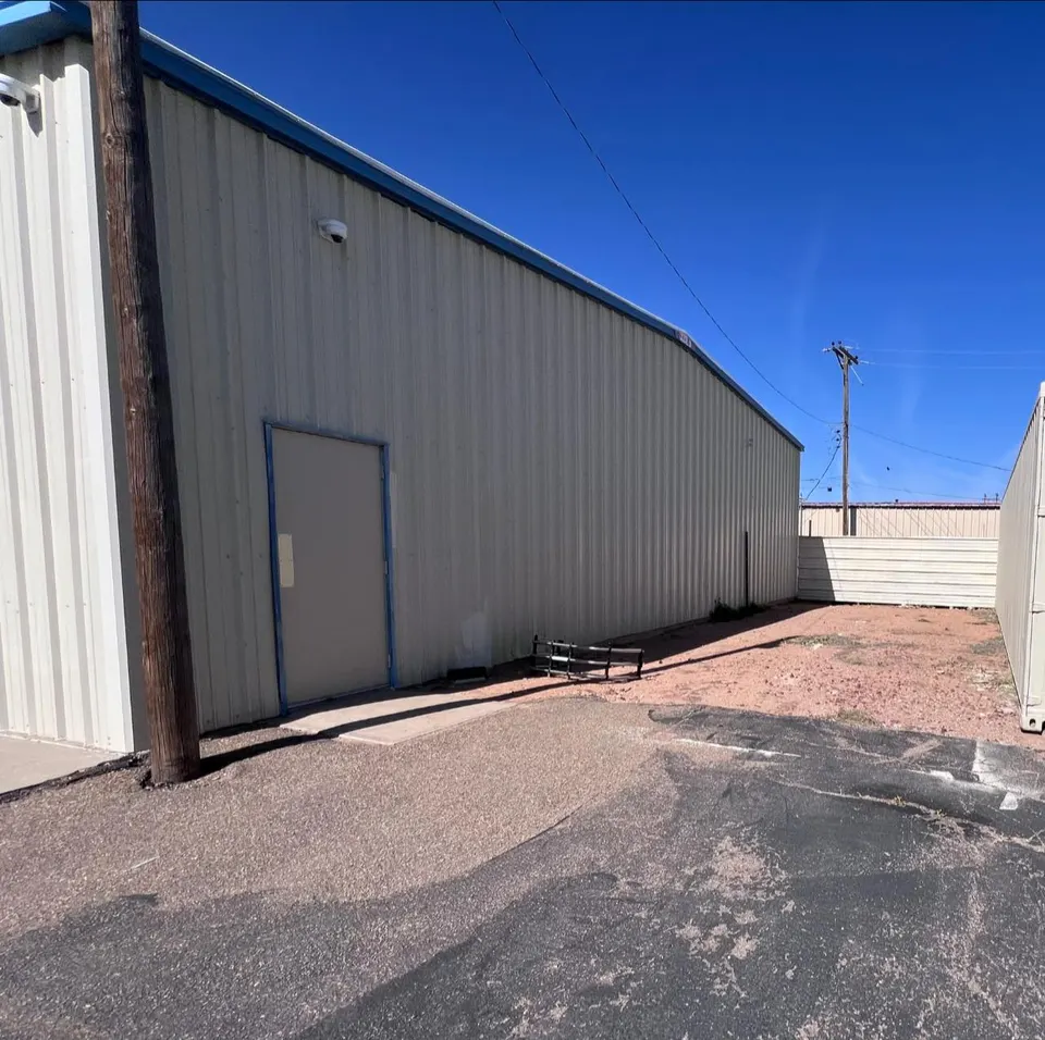 Side of Homerun Fabrication metal building showing utility setup and equipment