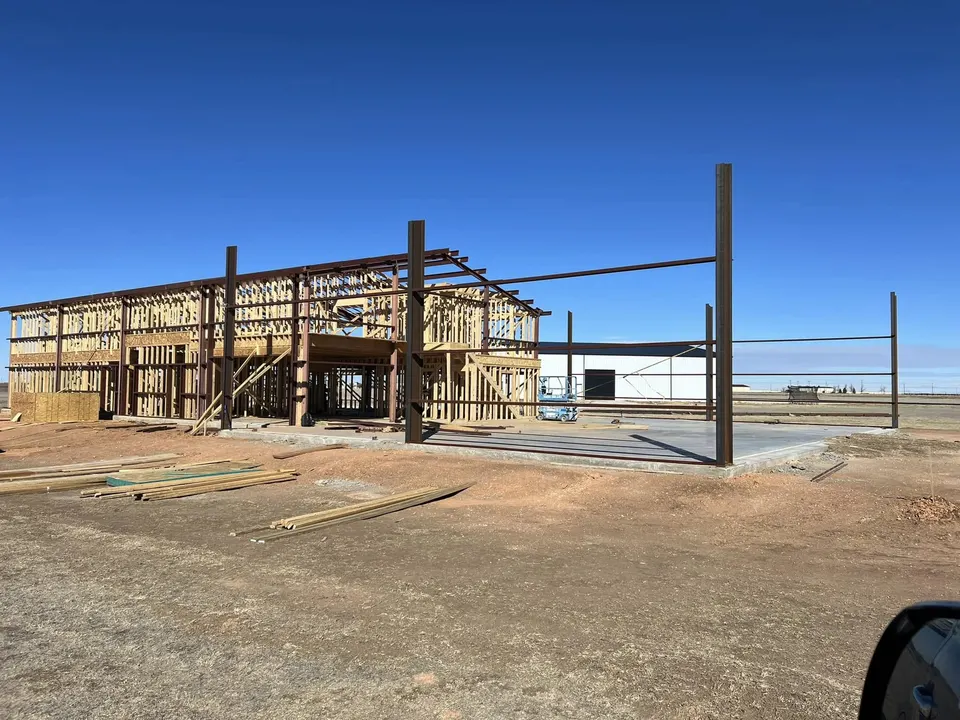 Two-story Homerun Fabrication building under construction with steel and wood framing